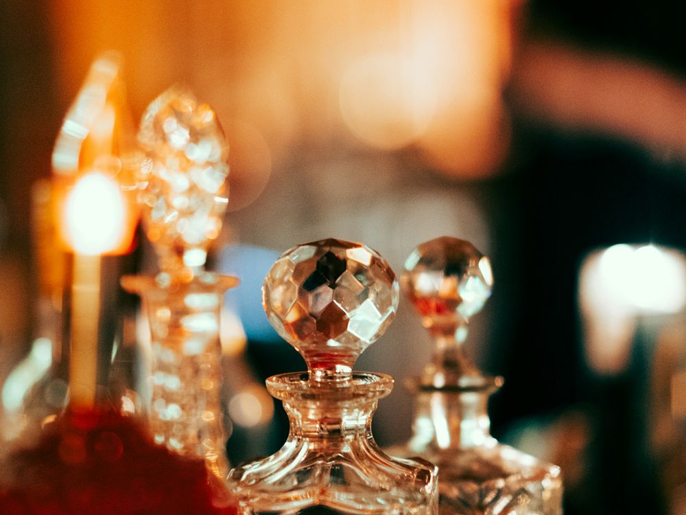 Glass flacons glowing by candlelight