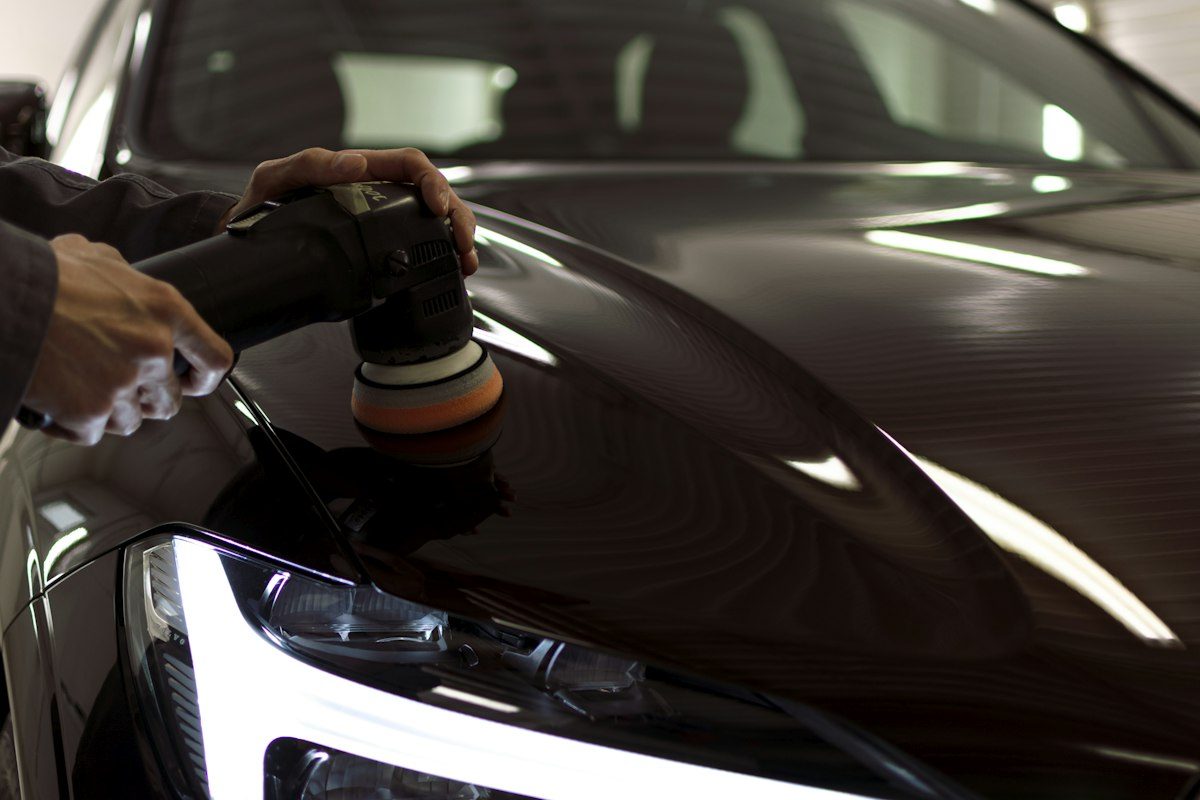 A person taking a picture of a car