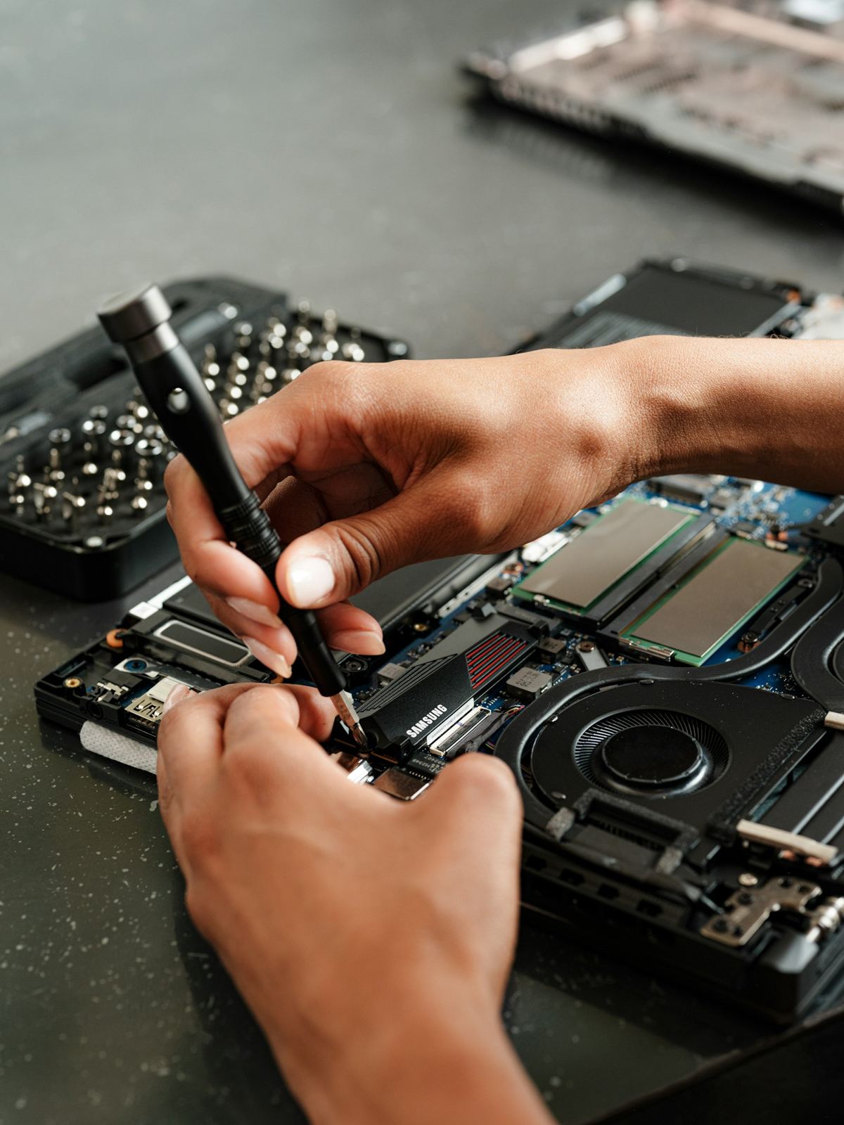 Technician repairing a laptop