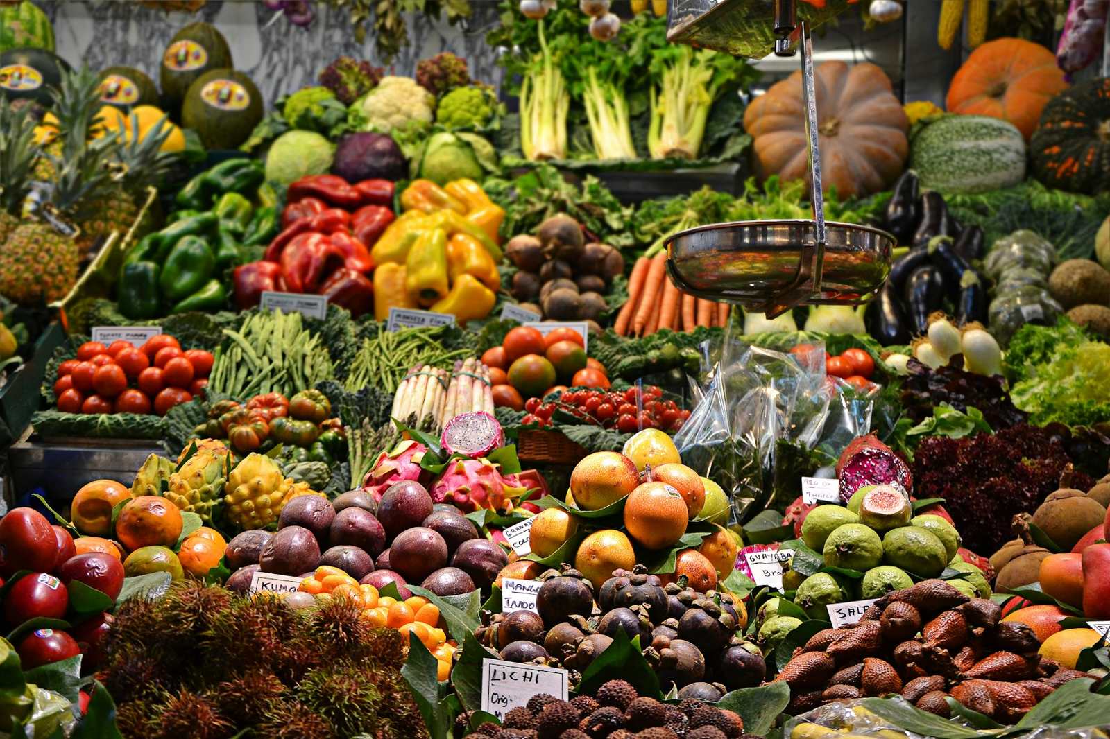 Colorful market stand piled with vegetables and fruit