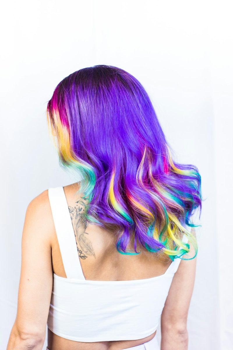 Woman in white top with multicolored hairstyle