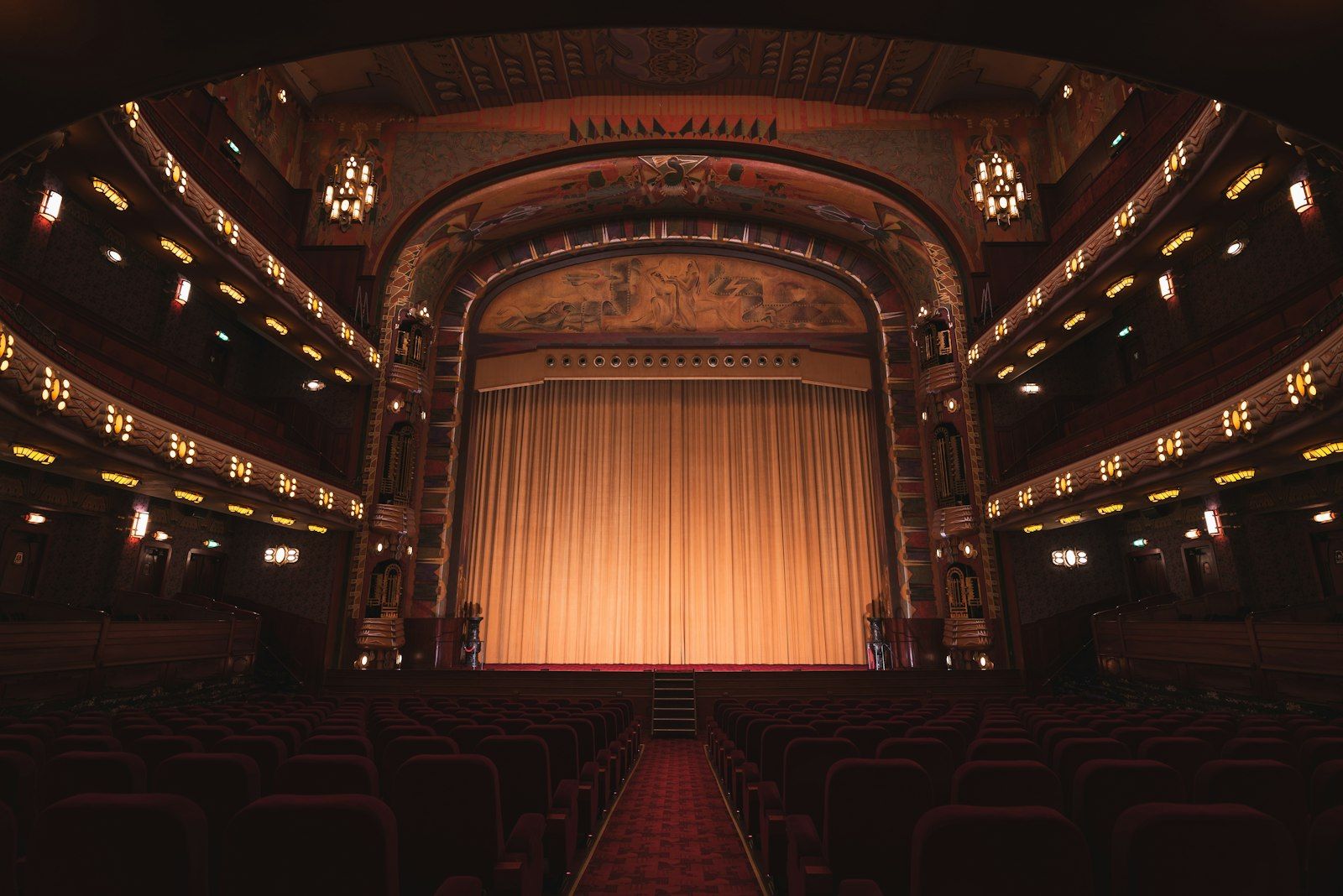Ornate theater auditorium with a lit stage