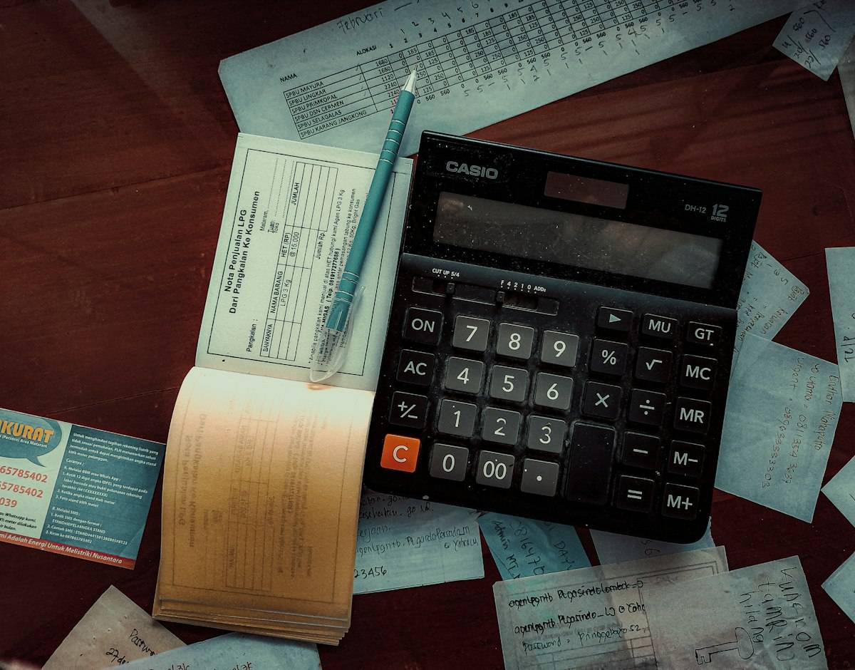 A calculator sitting on top of a wooden table