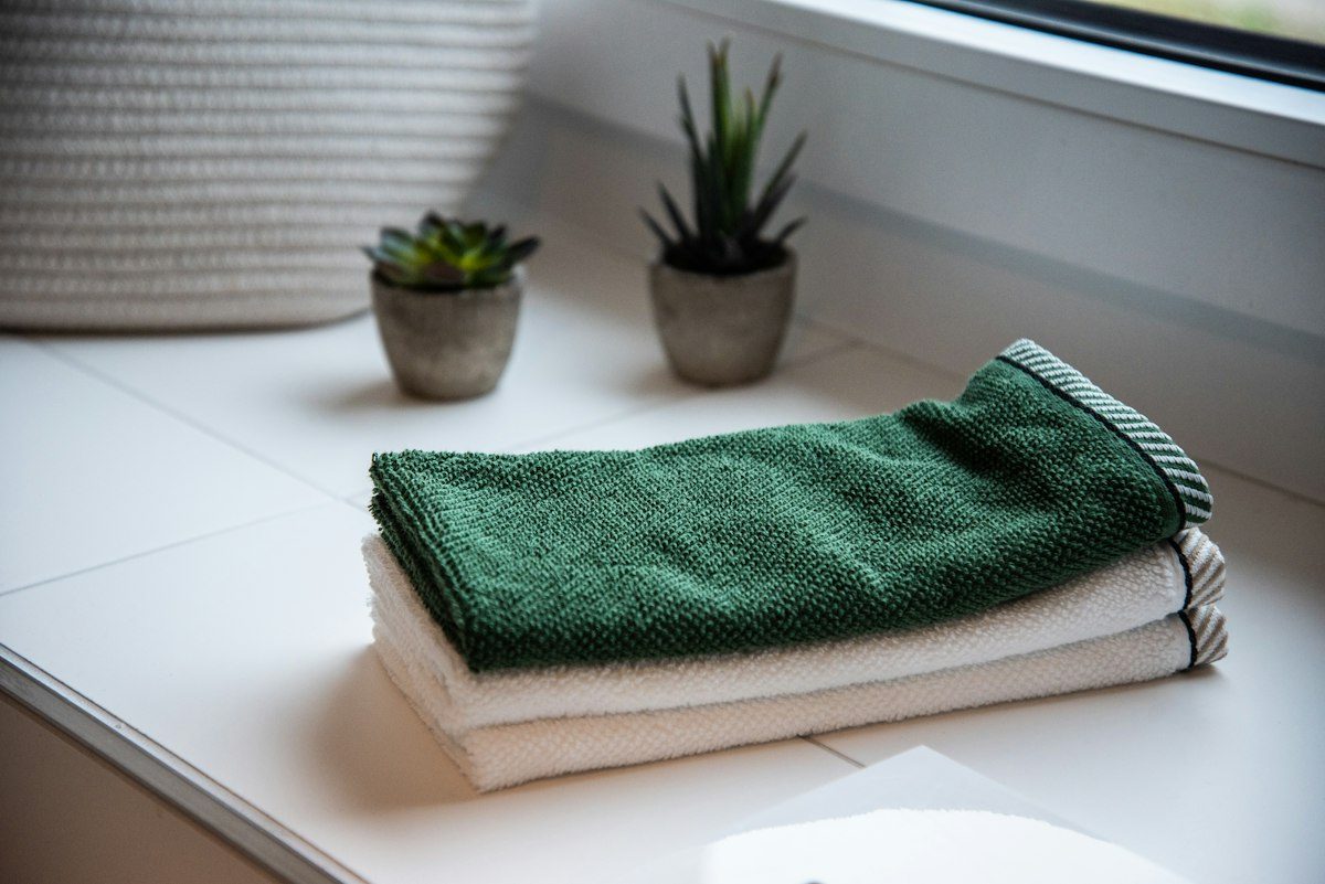 Folded towels near potted plants