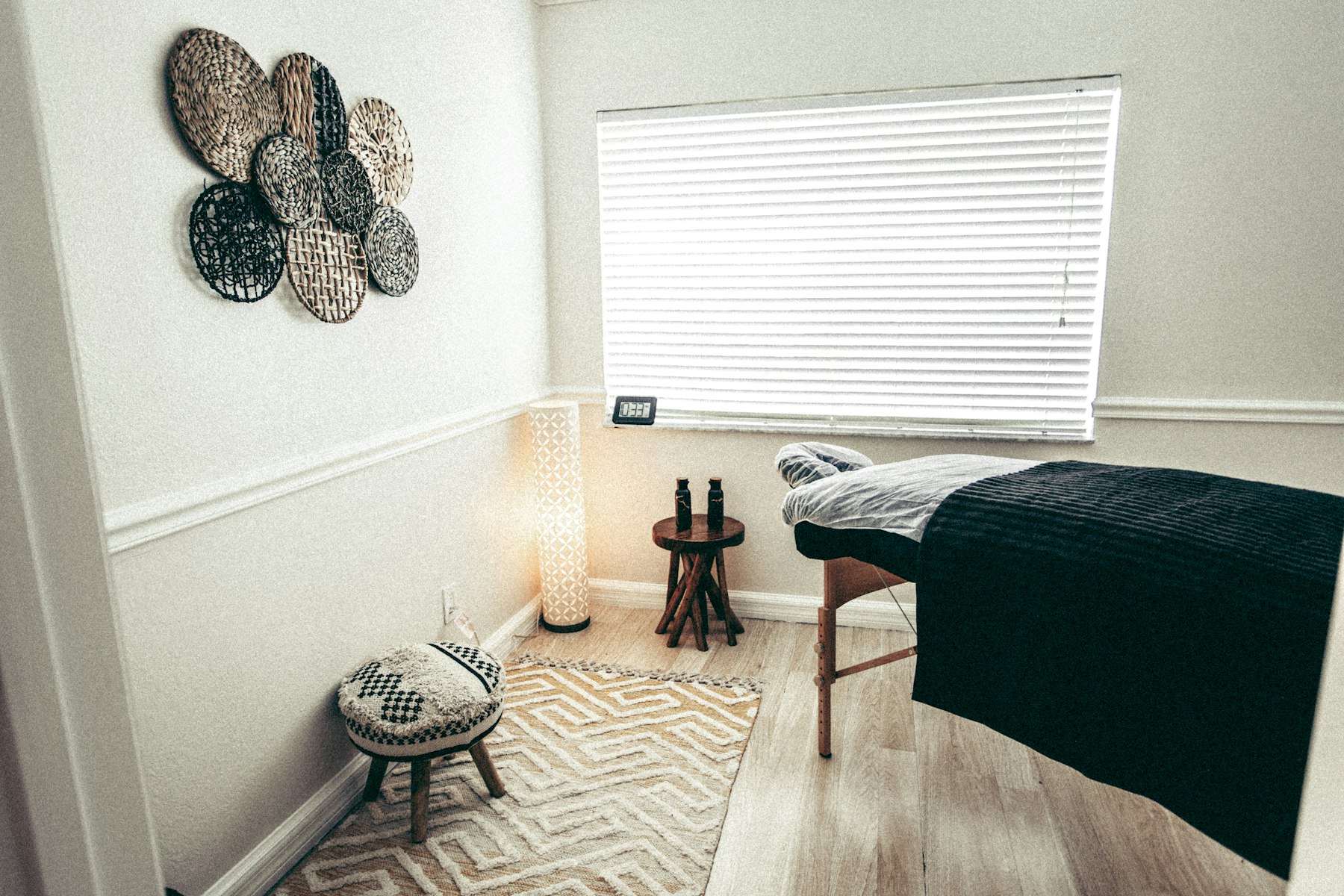 White and black round table near white wall