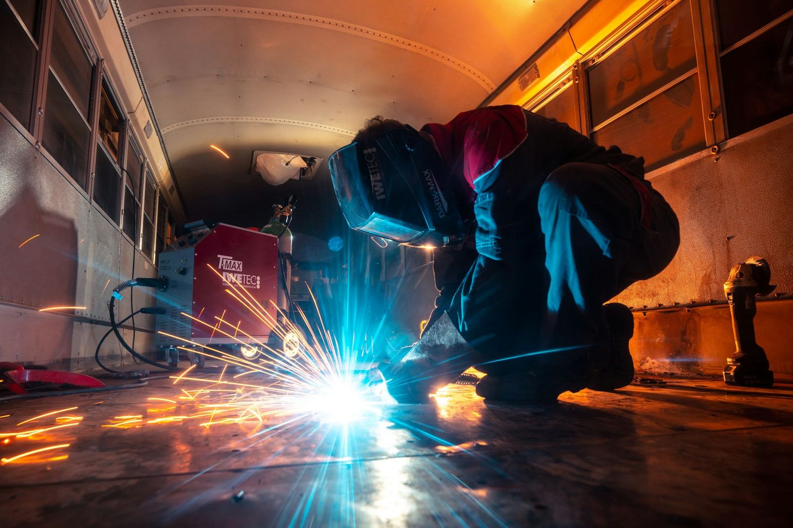 Welder working inside a vehicle body