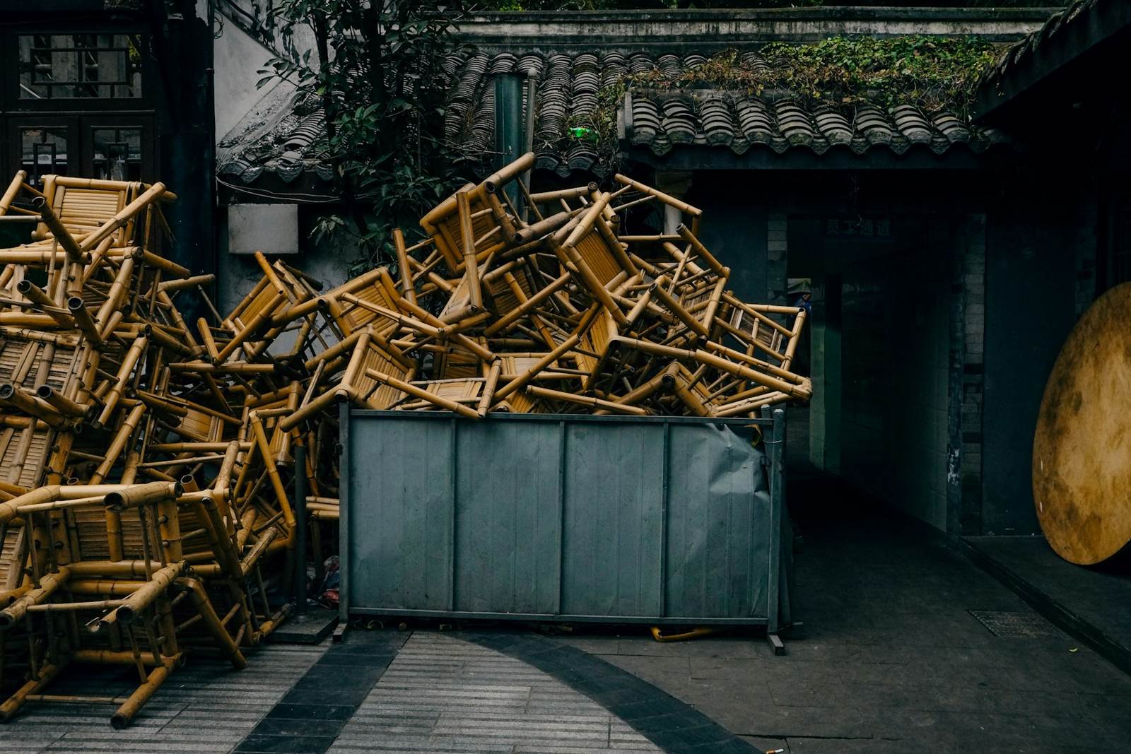 Stacked chairs beside a container