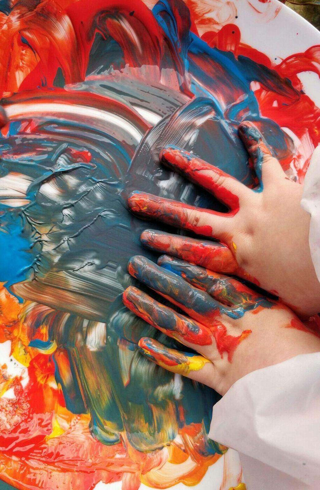 Child painting with bright colors