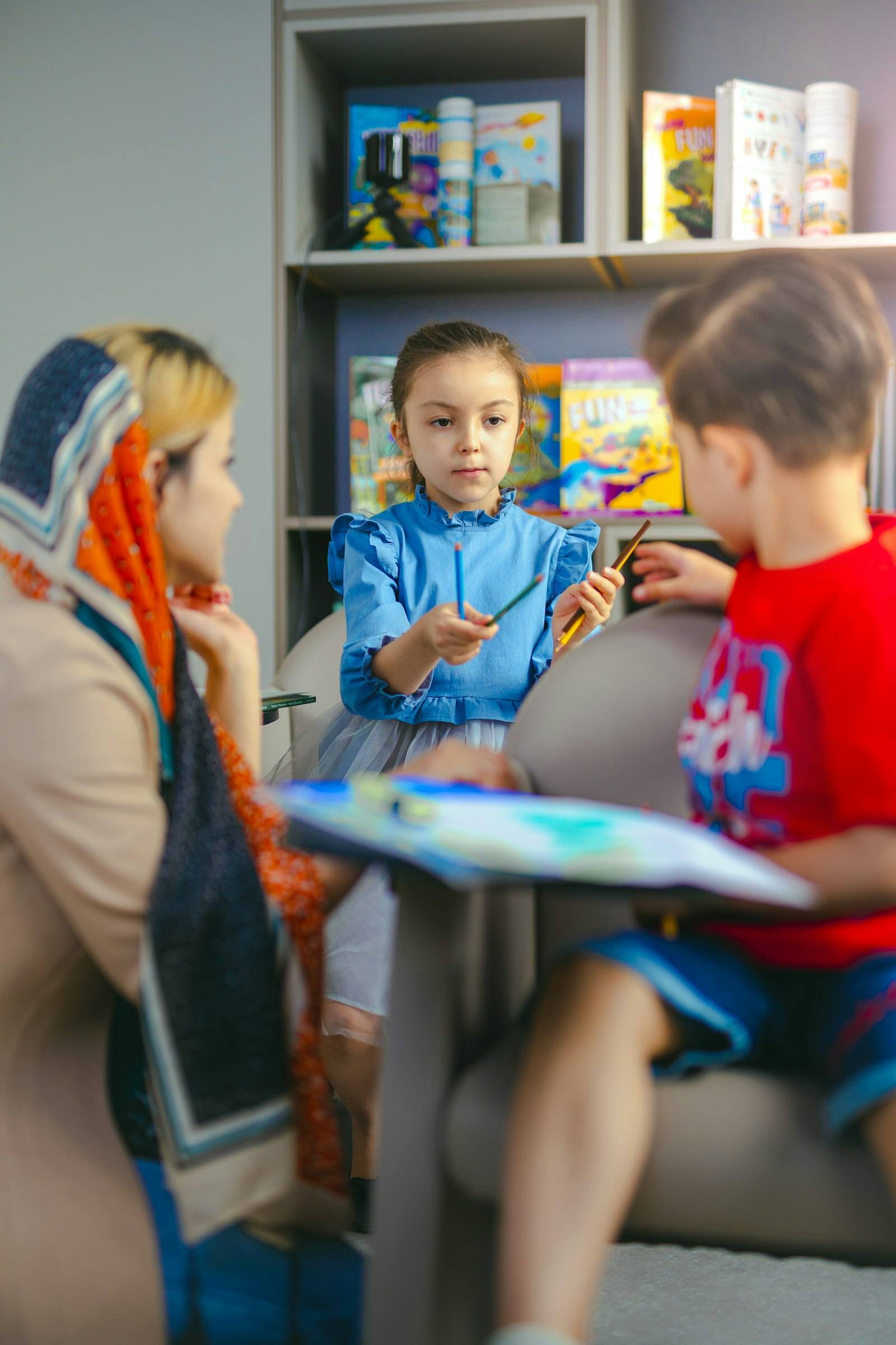 Children painting together at a table