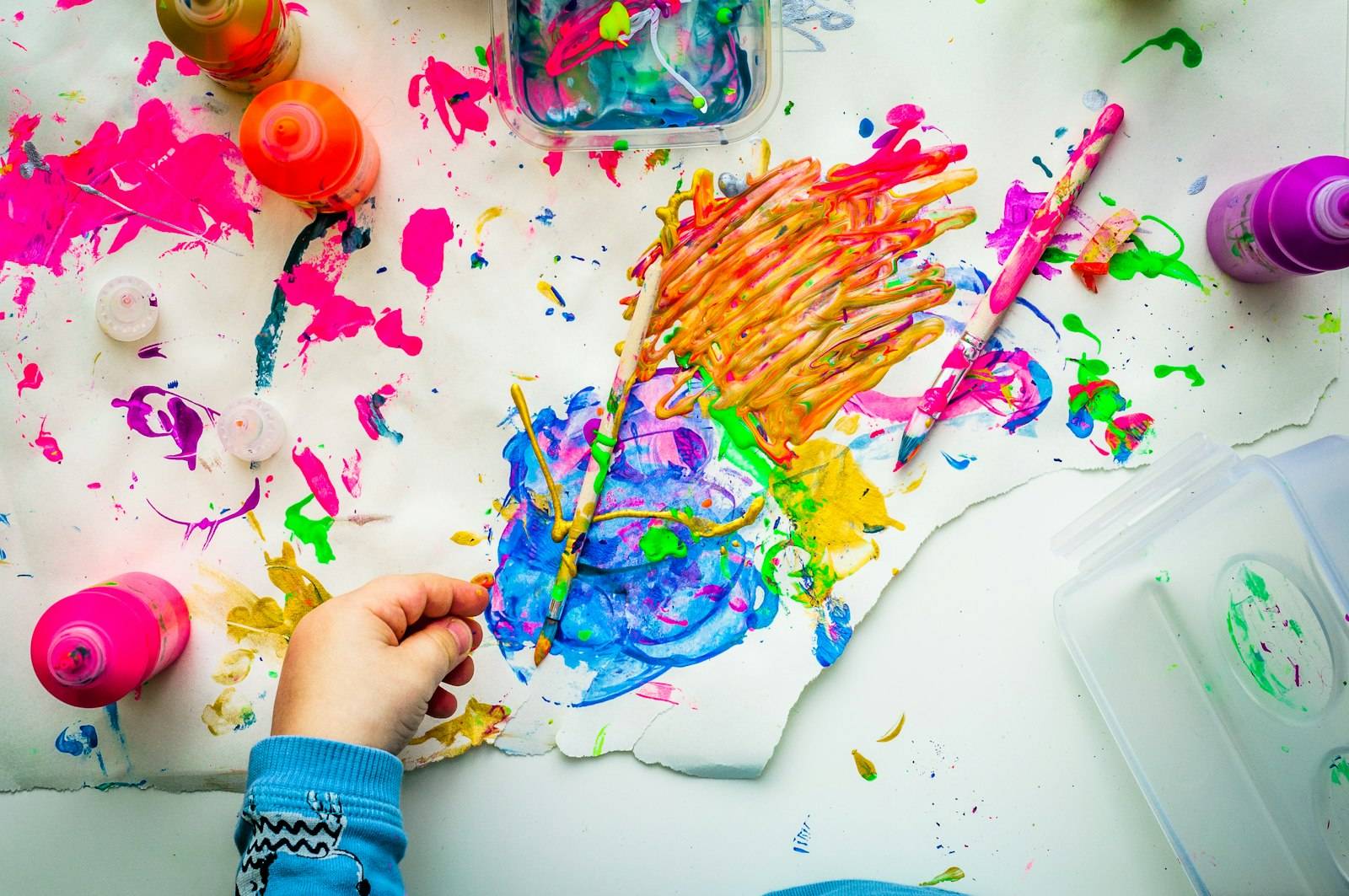 Child painting with bright colors