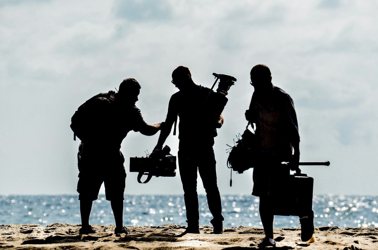 Crew silhouettes on a beach