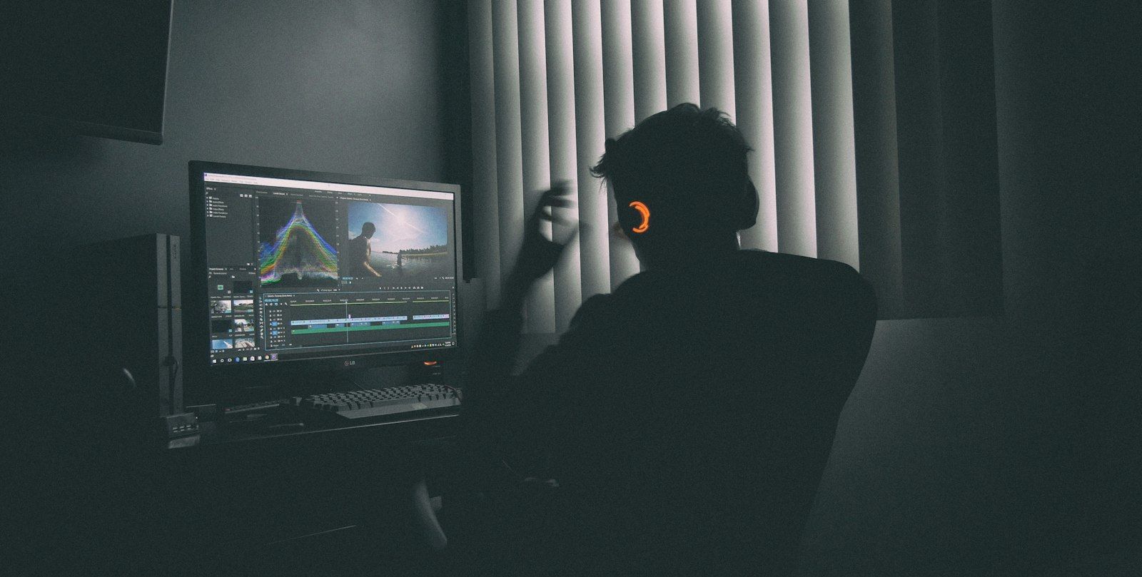 Editor working in a dark edit suite