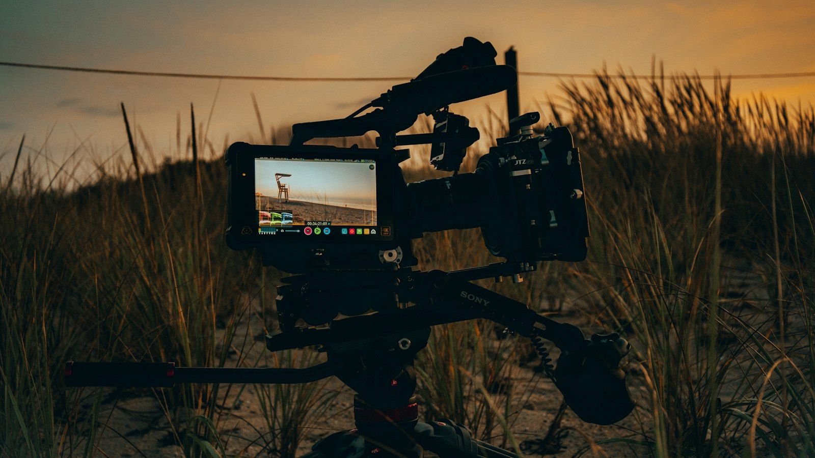 Camera rig in tall grass at sunset