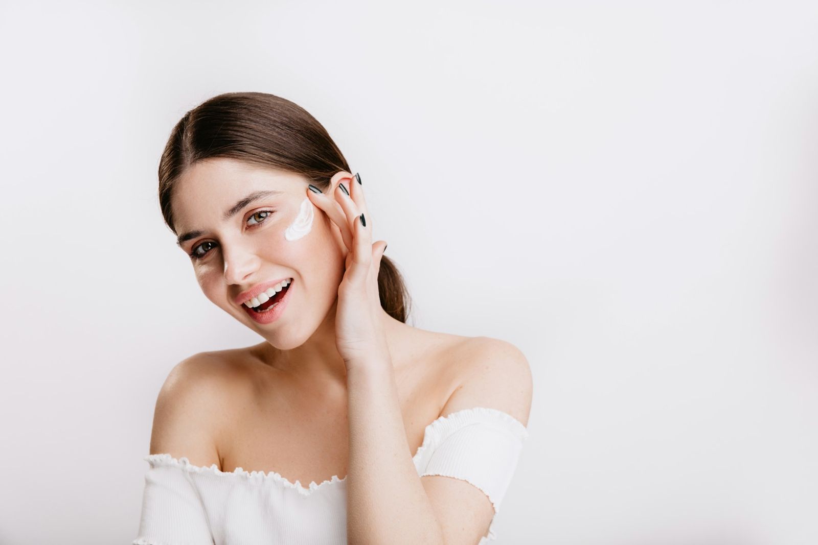 Client touching her face and smiling