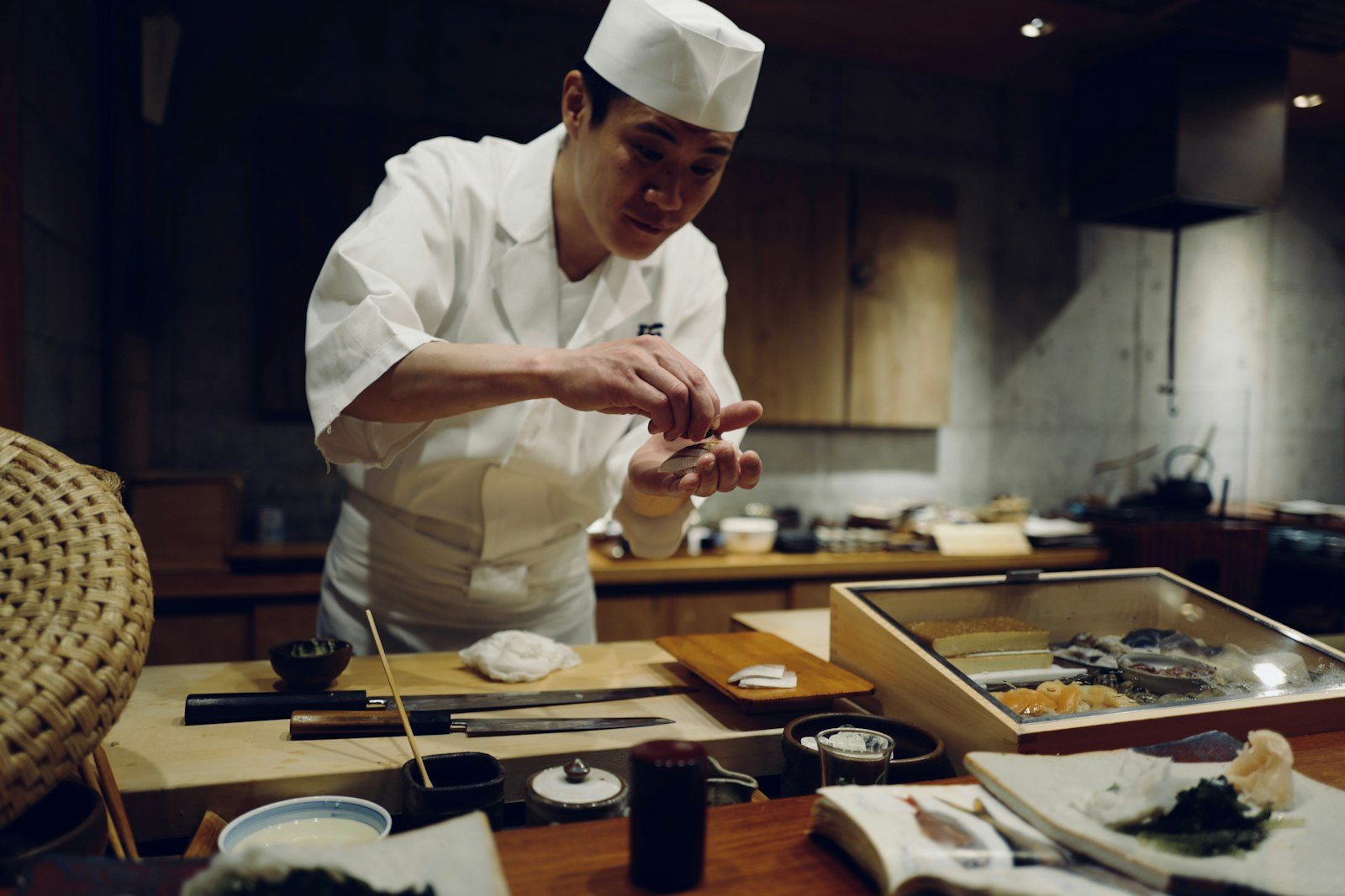 A sushi chef's hands shaping nigiri