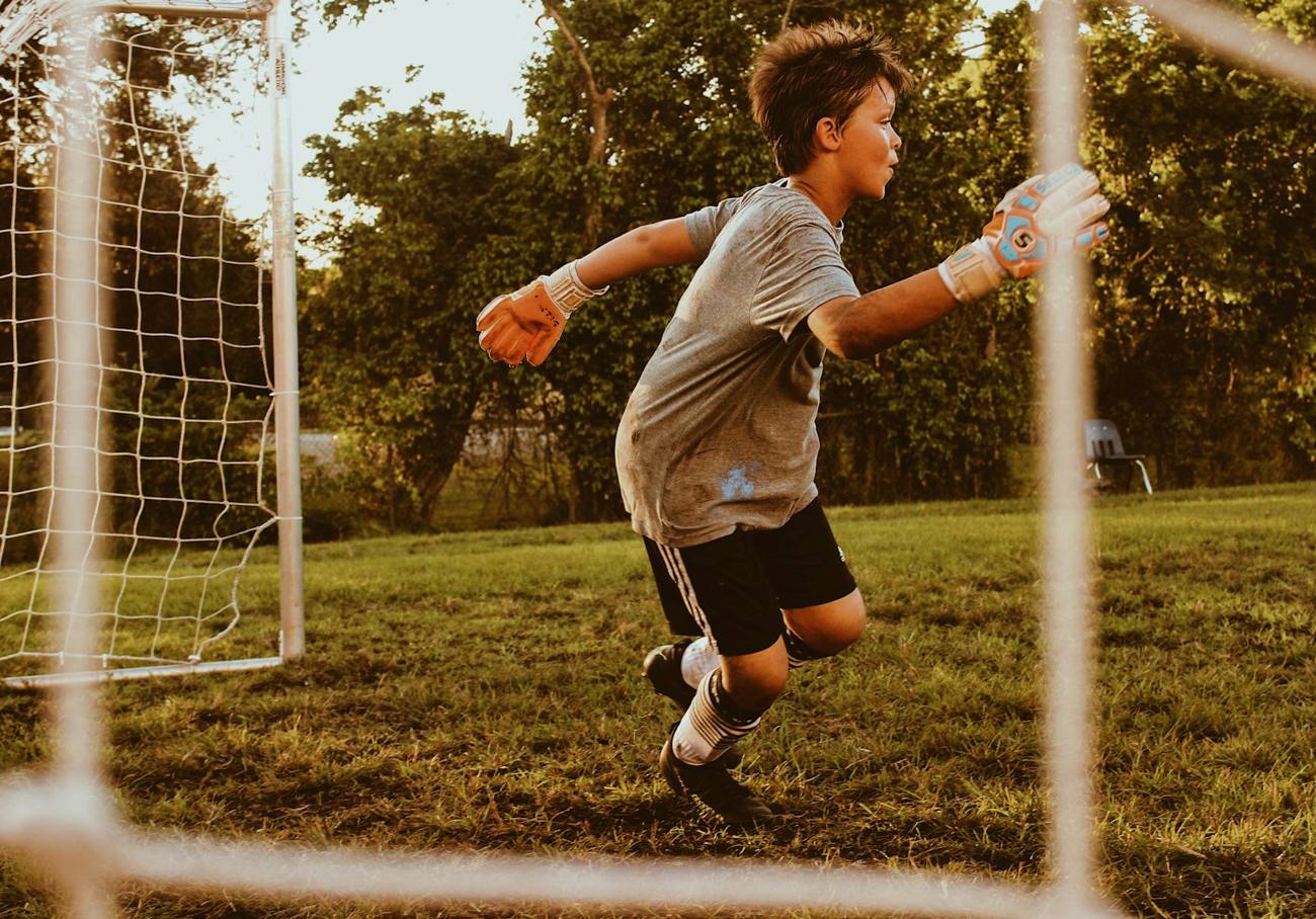 Young goalkeeper diving