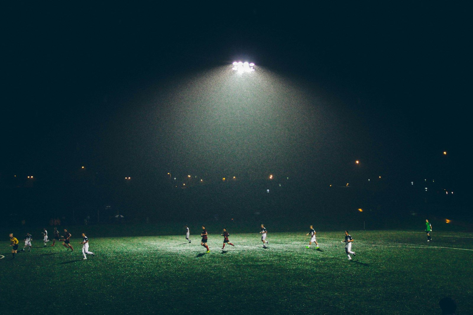 Players under floodlights at night