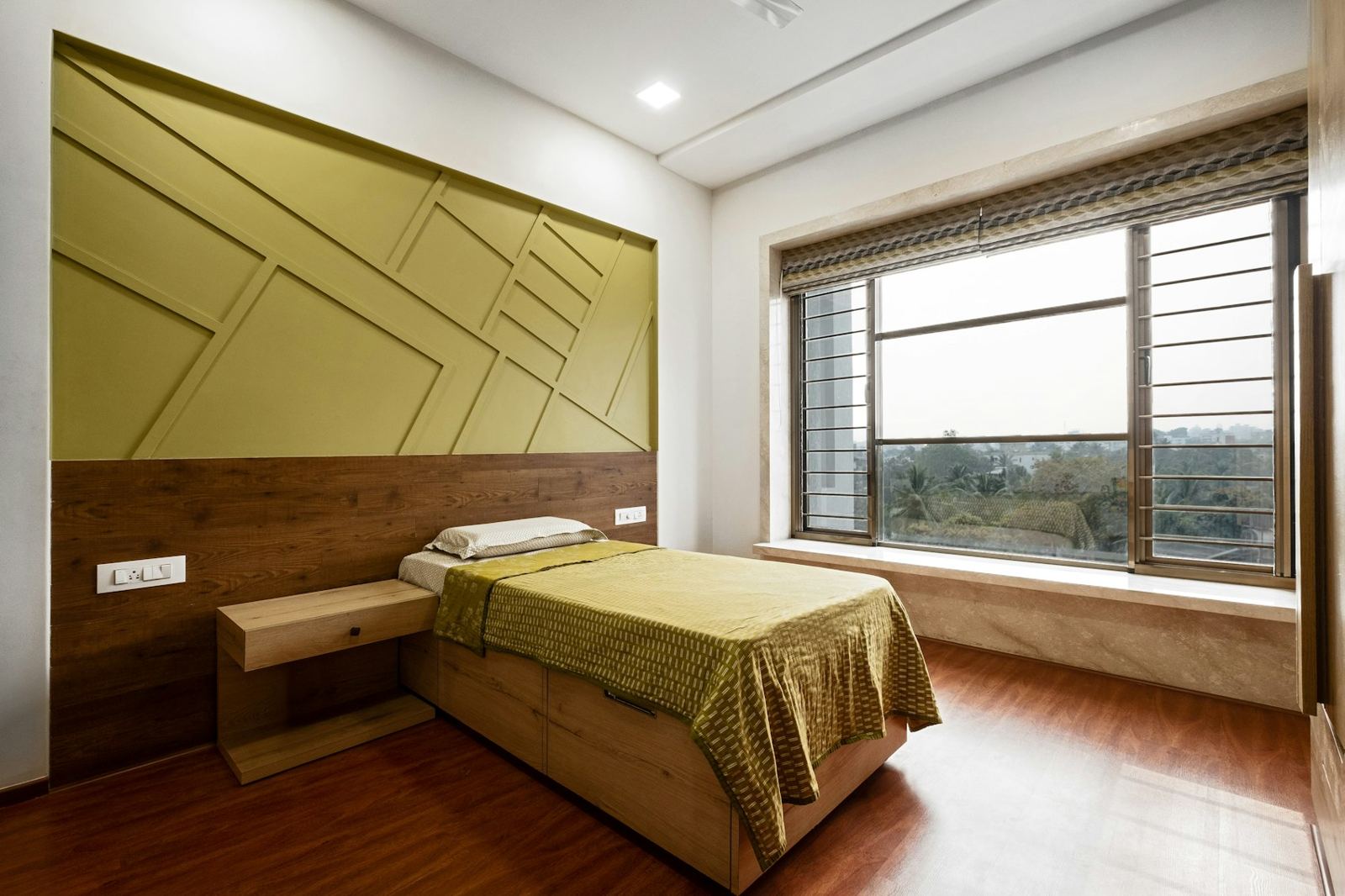 Bedroom with an olive painted feature wall