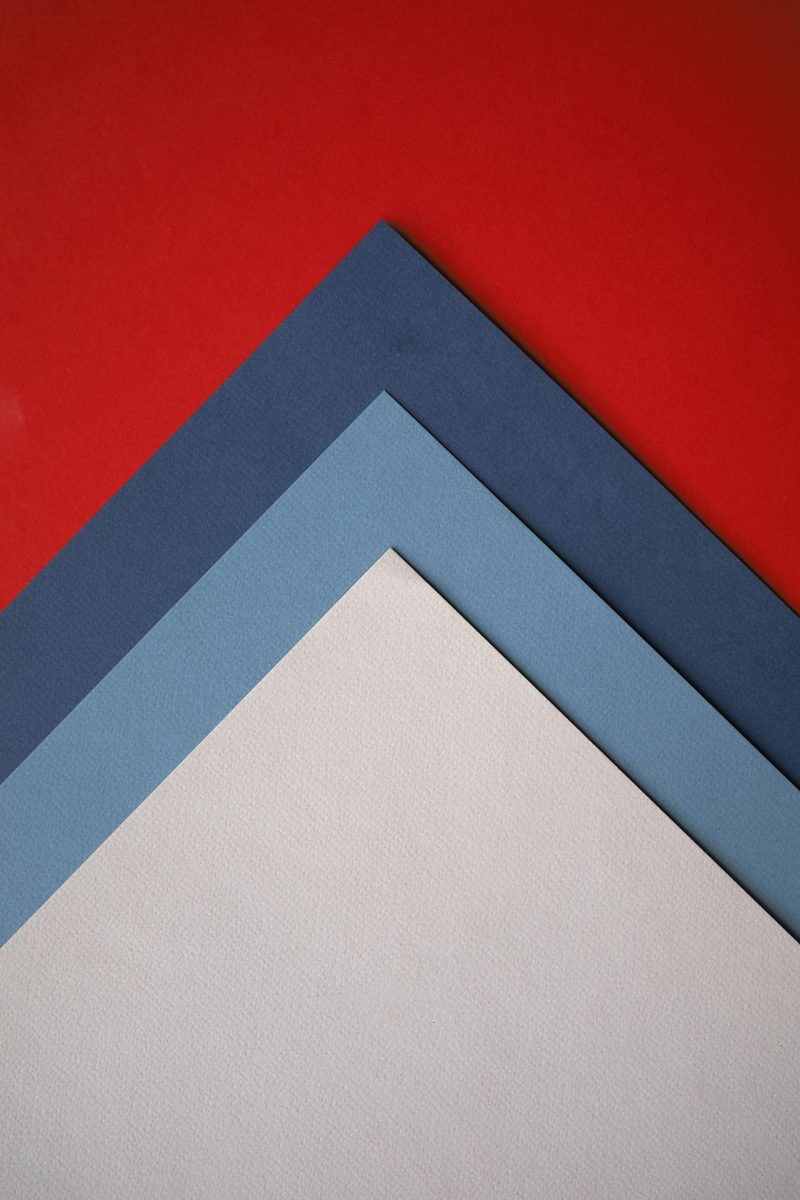 A close up of three different colors of paper