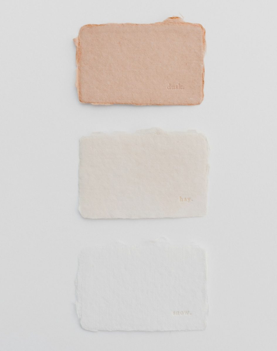 Three different colors of paint on a white surface