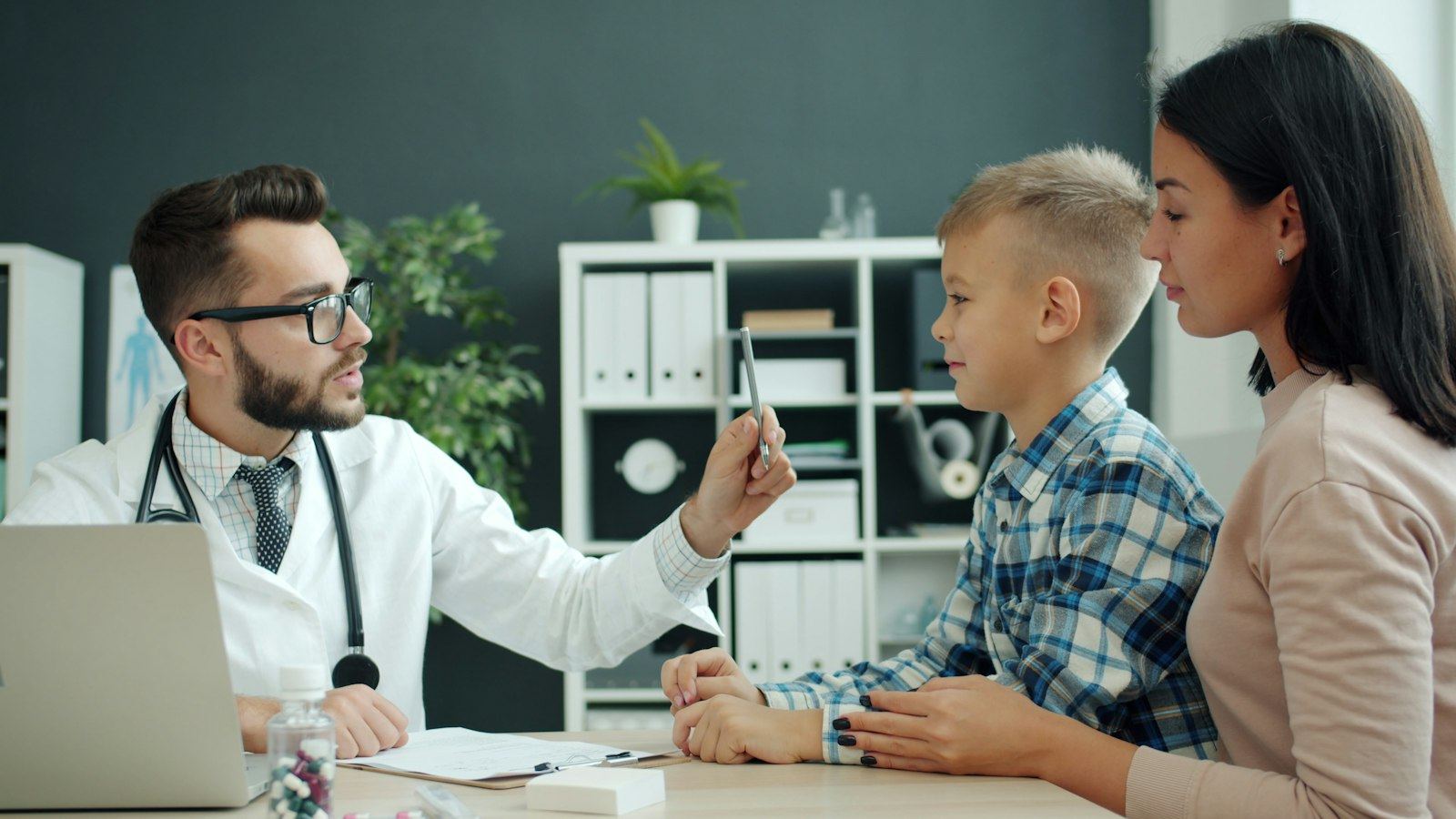 Doctor talking with a child and parent