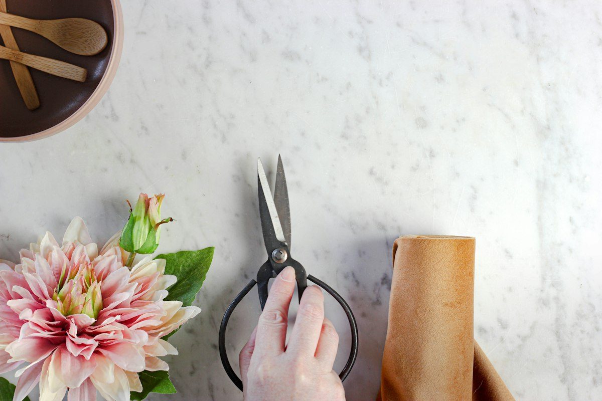 Person holding black handled scissors