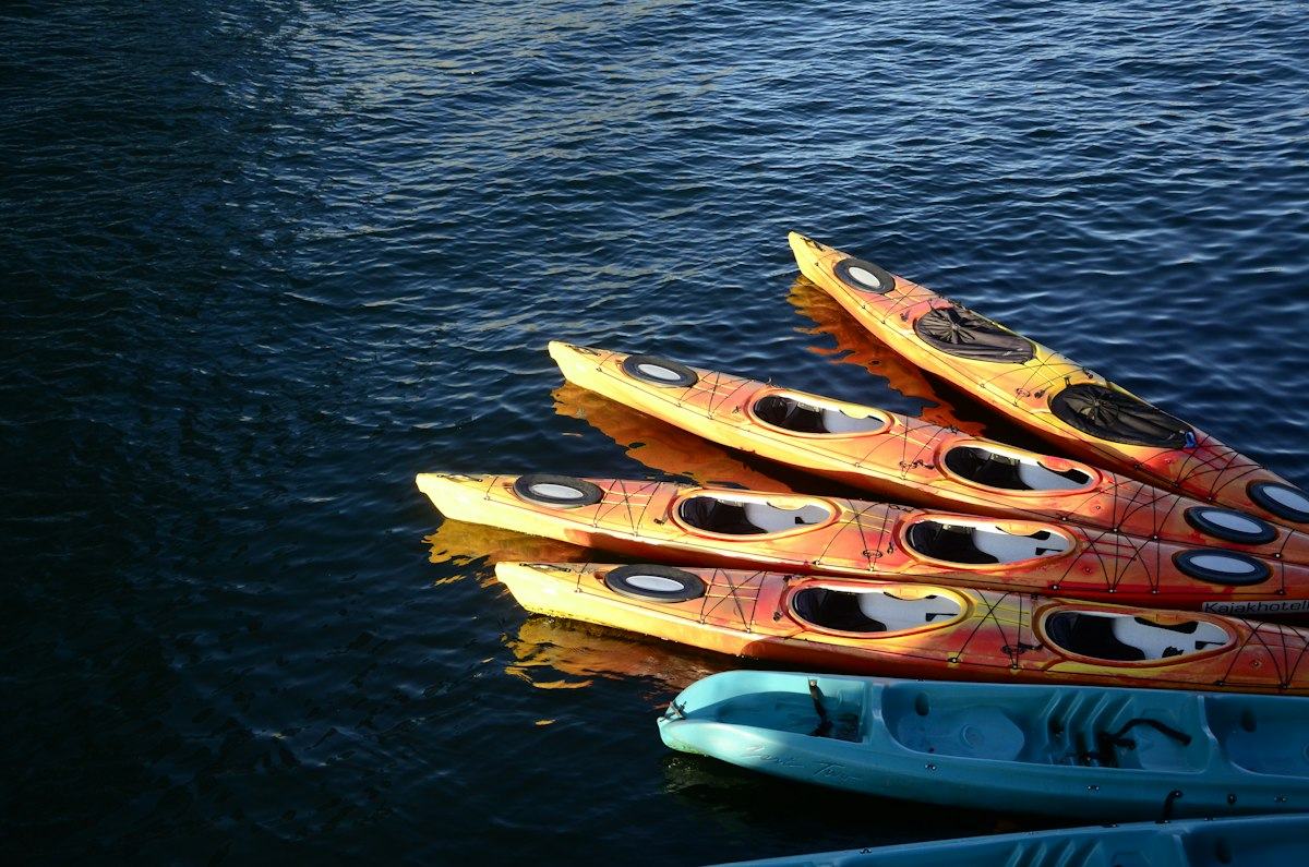 Brown and blue wooden boat on body of water during daytime