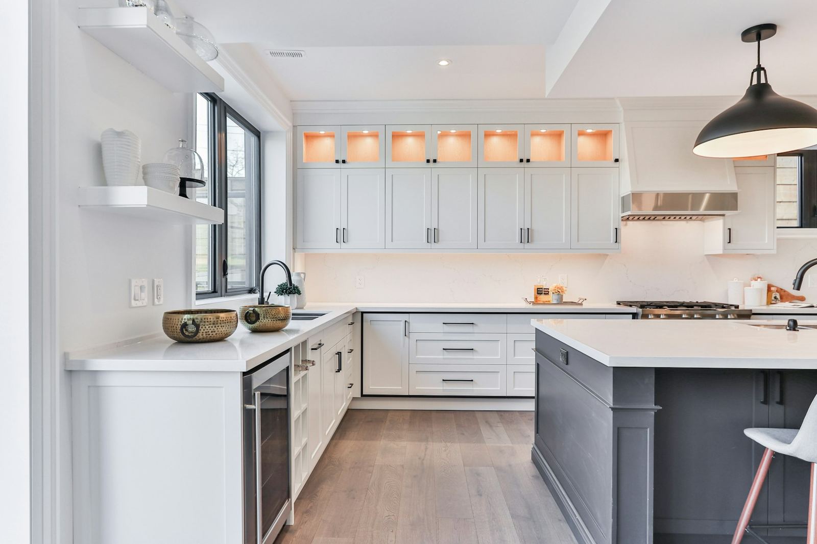 Bright kitchen with a dark island and open shelves