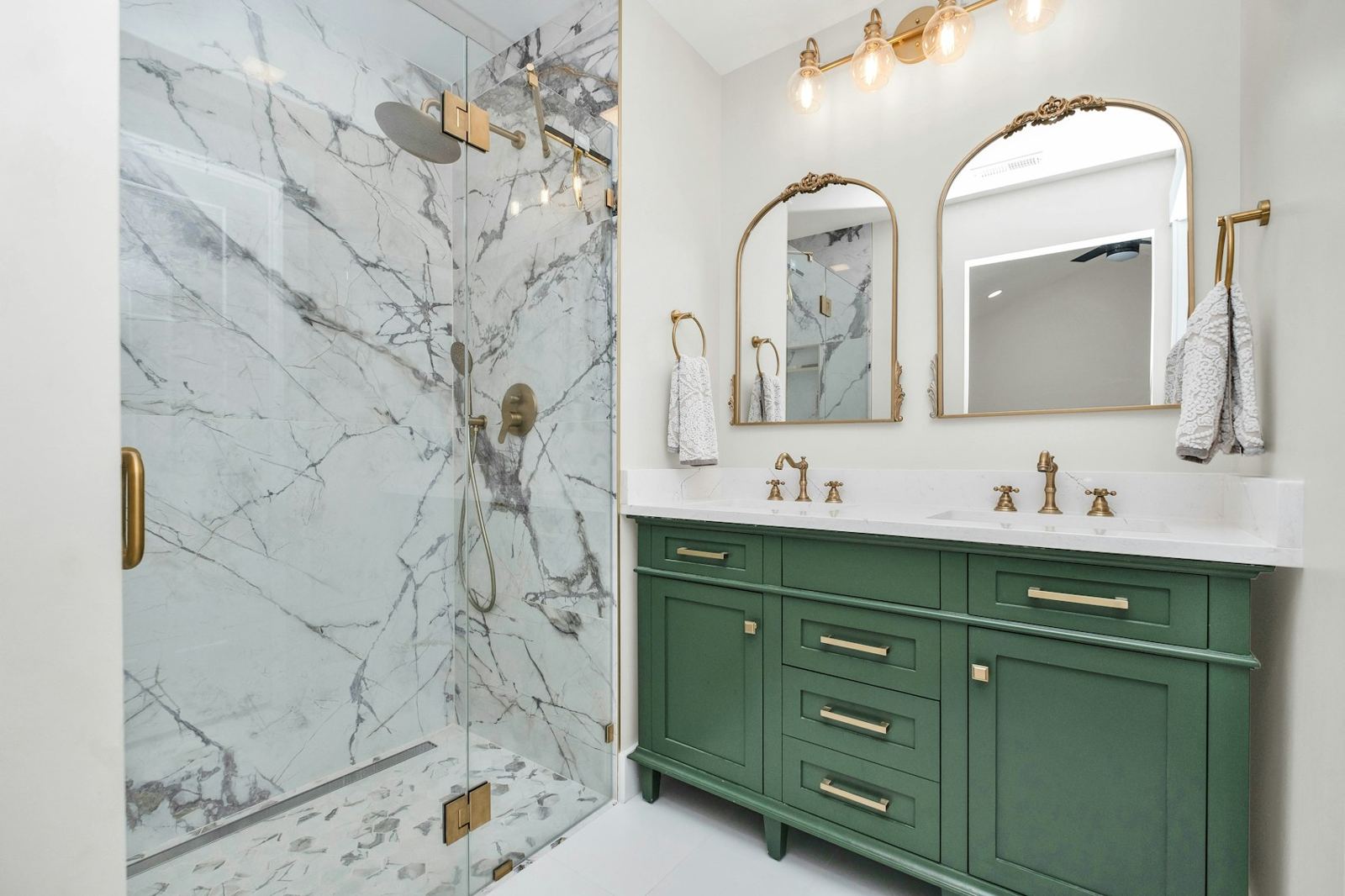 Bathroom with a green vanity and marble shower