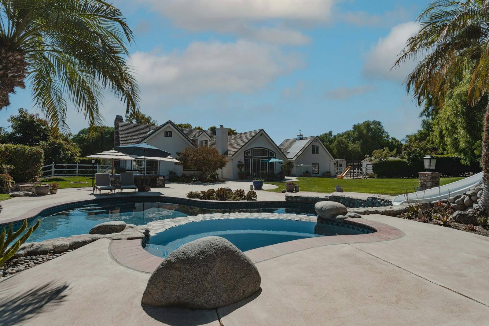 Naturalistic pool with boulders and spa