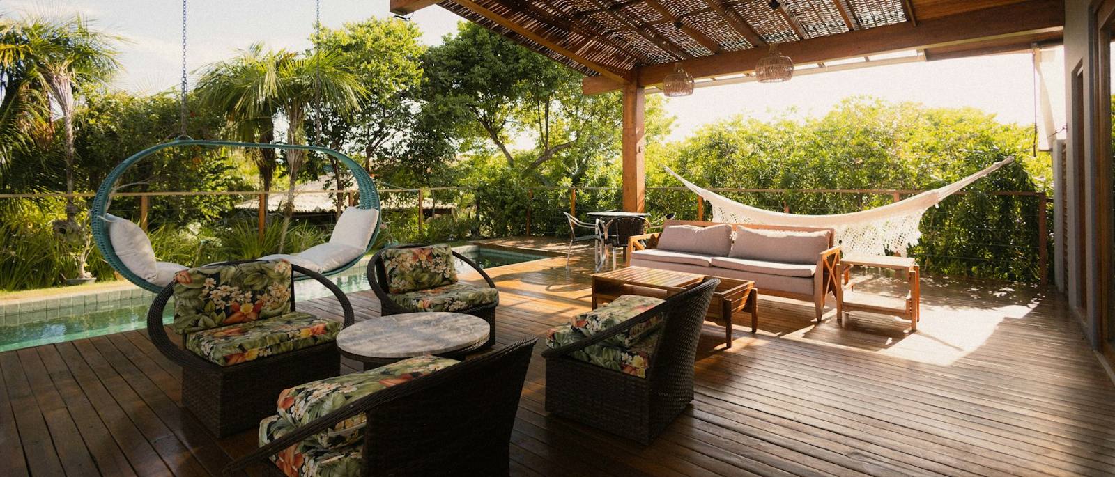 Covered patio with seating and pool view