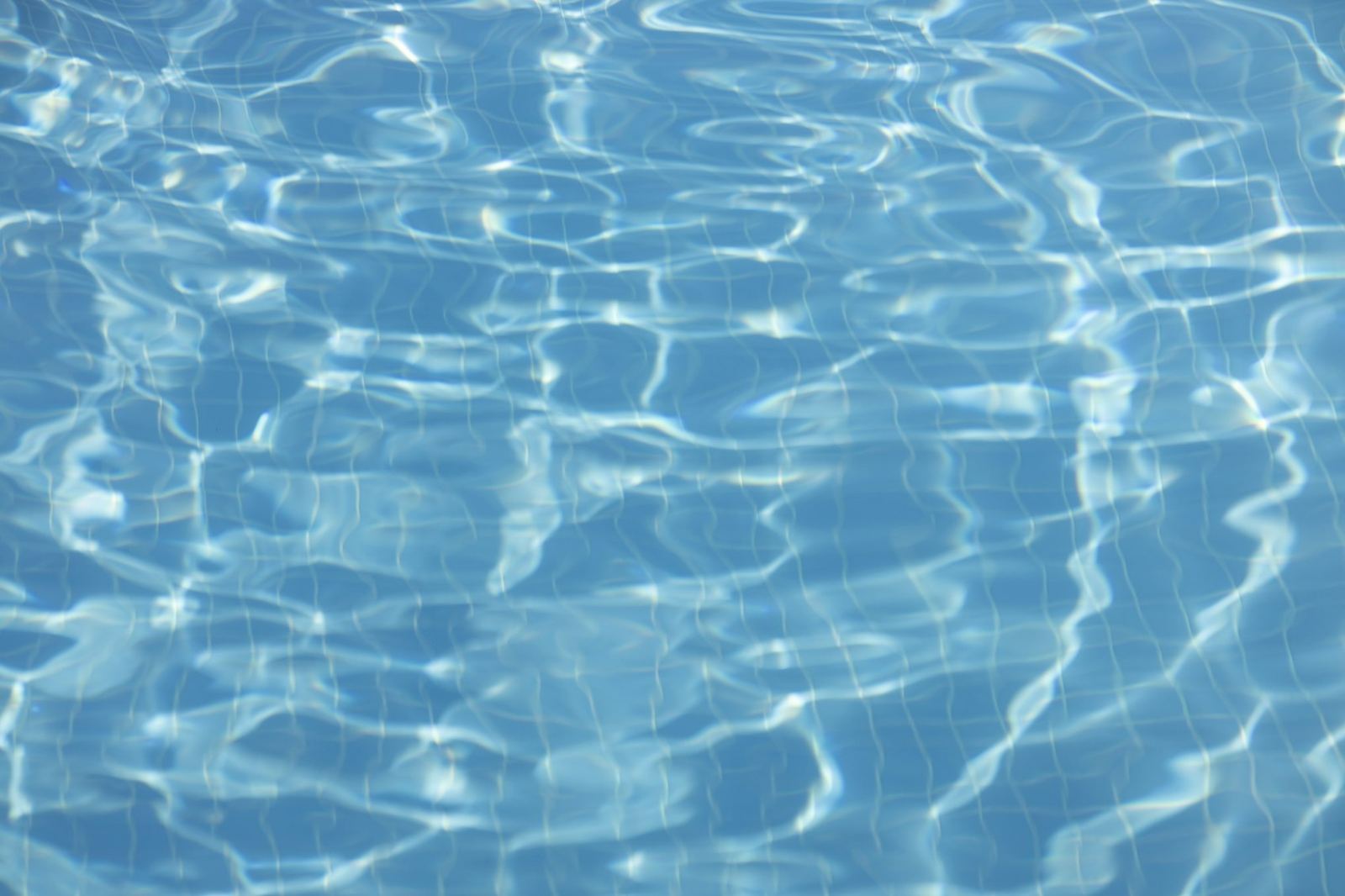 Tiled pool floor in sunlight