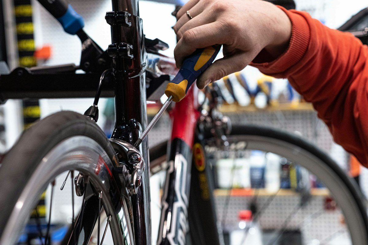 A person is working on a bike in a bike shop