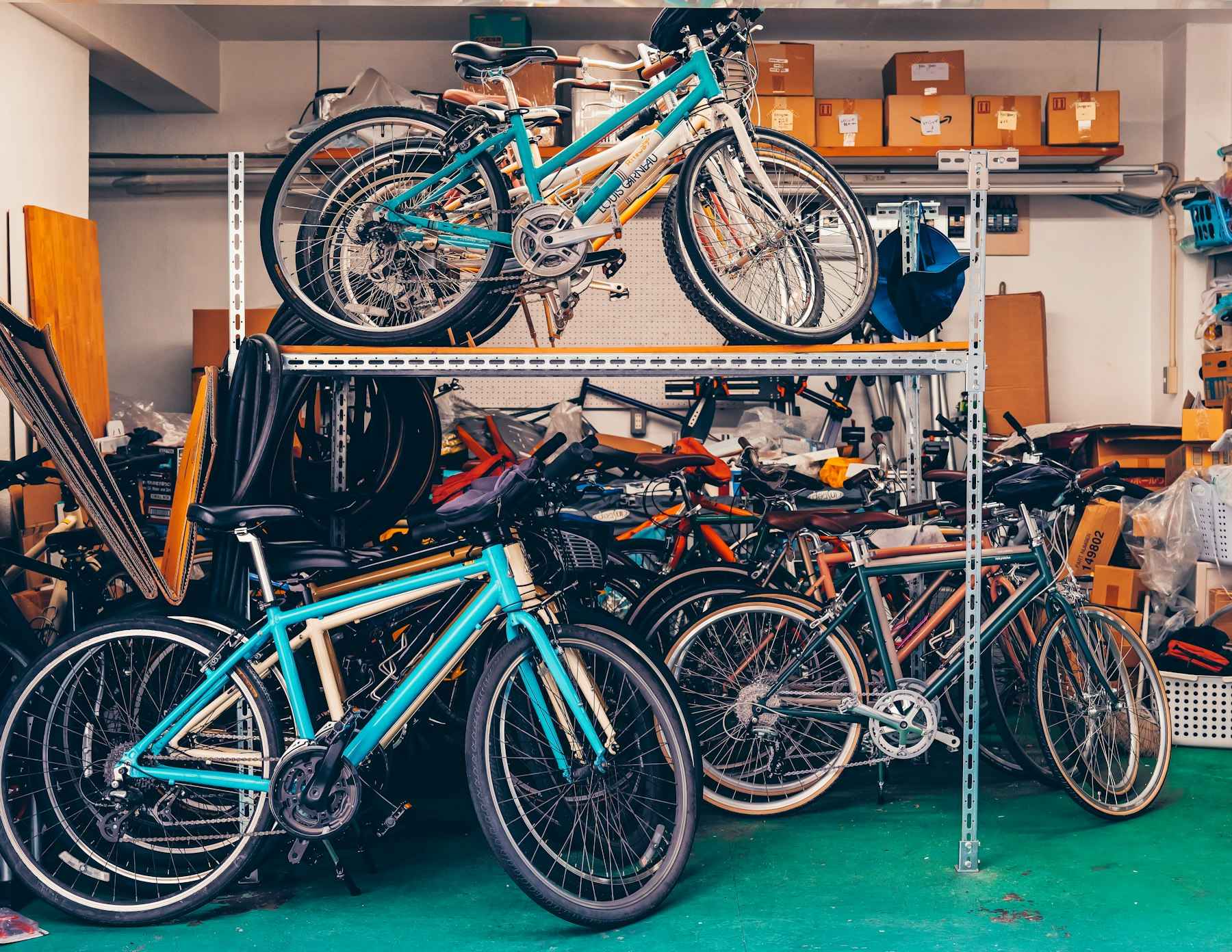 Multiple bicycles stored on shelves in a garage