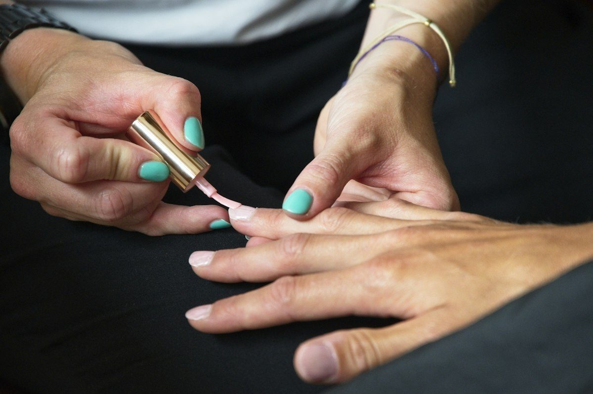 A person's hands with painted nails
