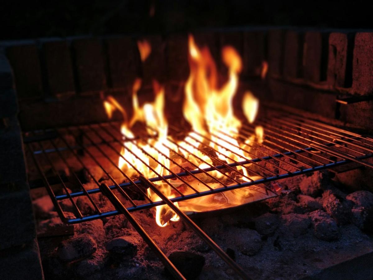 Coals glowing under a grill