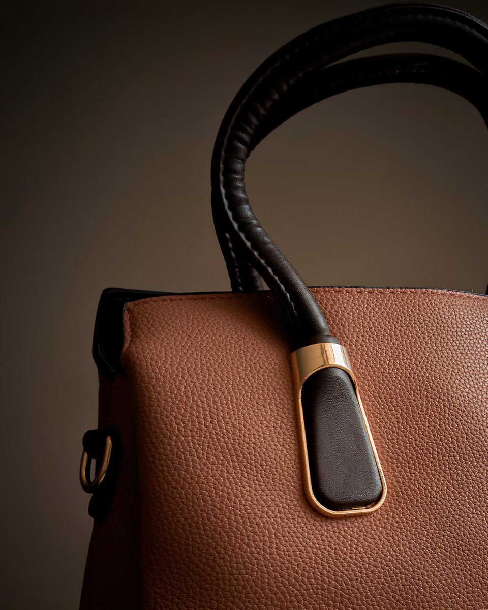 A brown and black handbag is on display