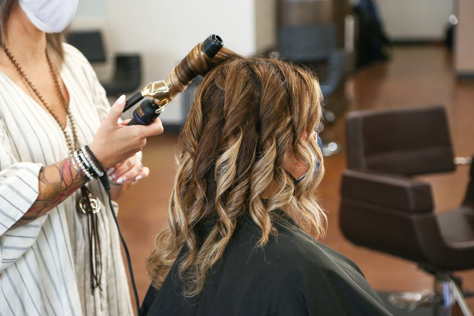 Soft curls being styled with a curling iron