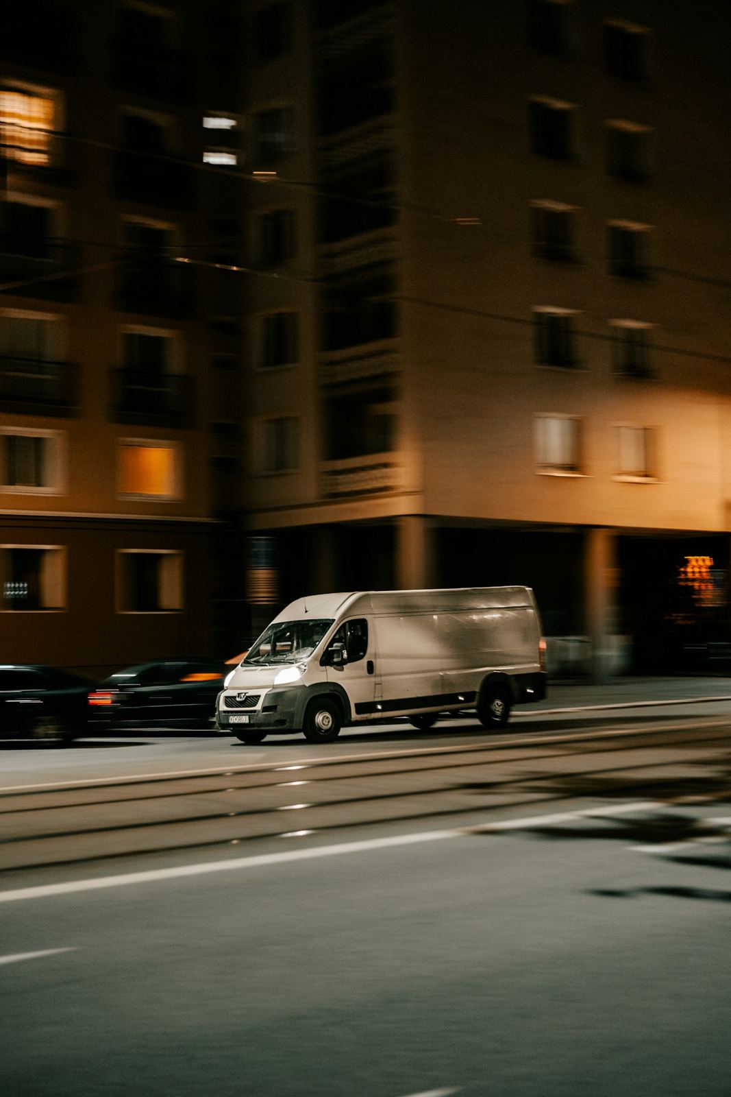 Delivery van on a city street at night