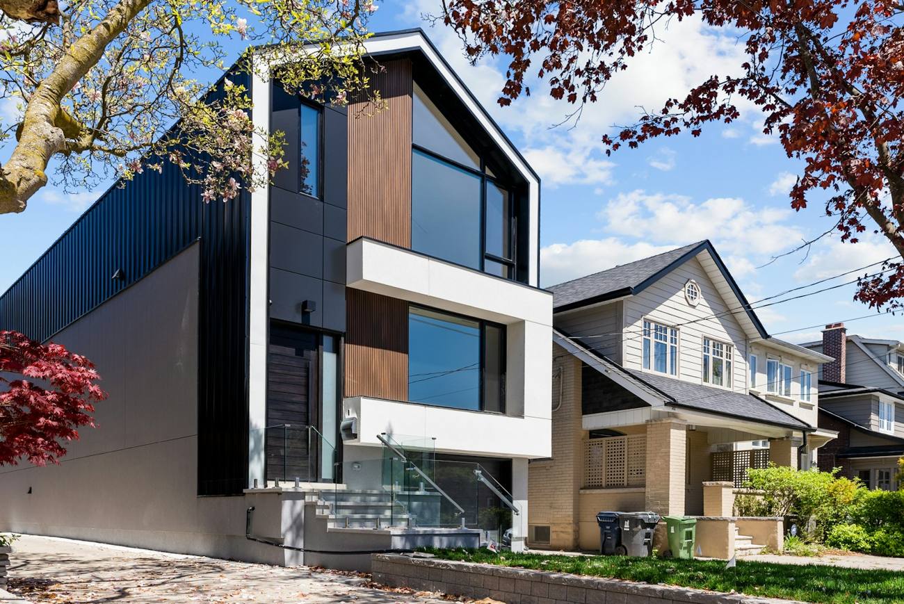 Modern infill home with timber and white panels
