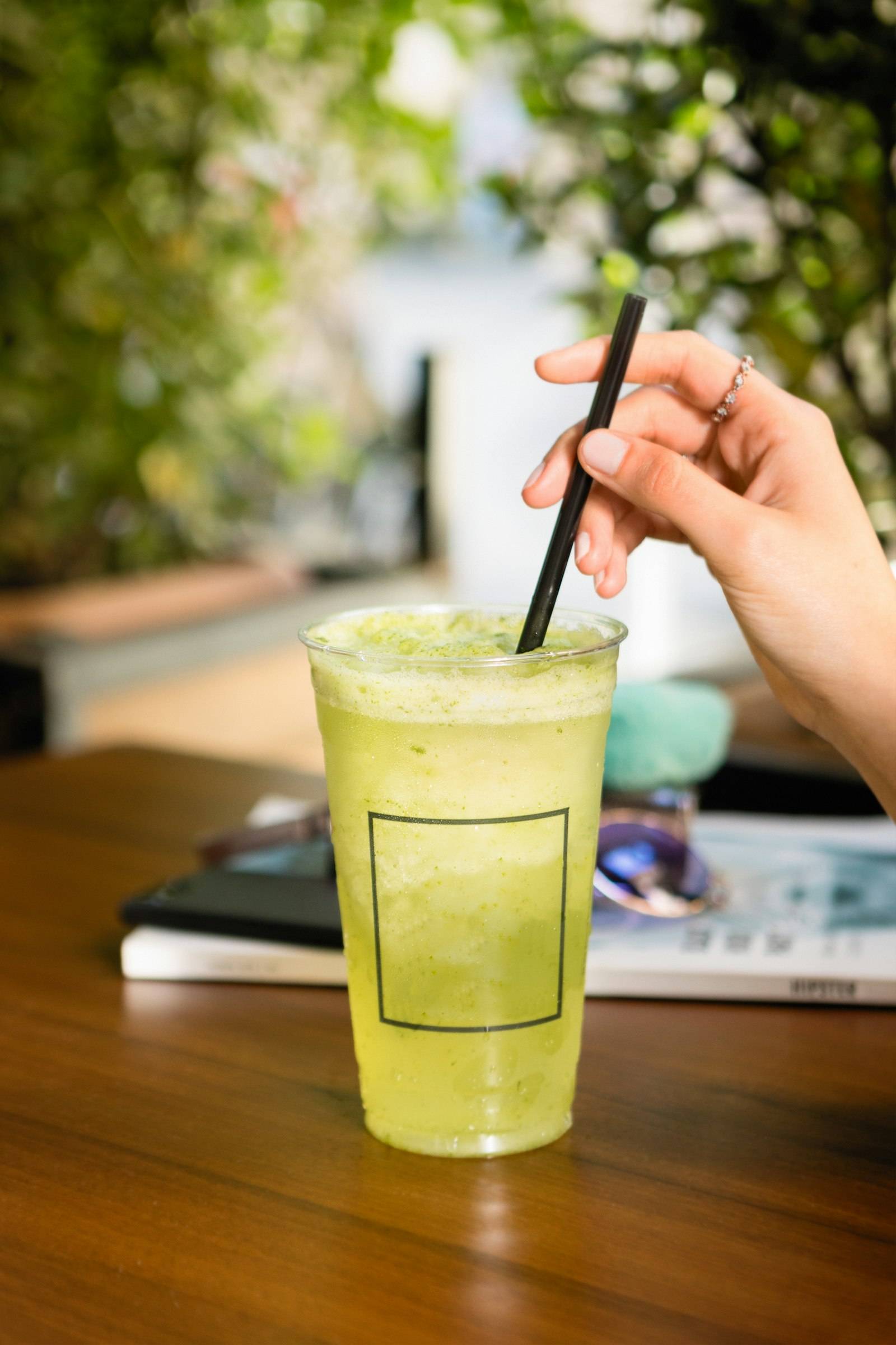 Green iced drink with a straw