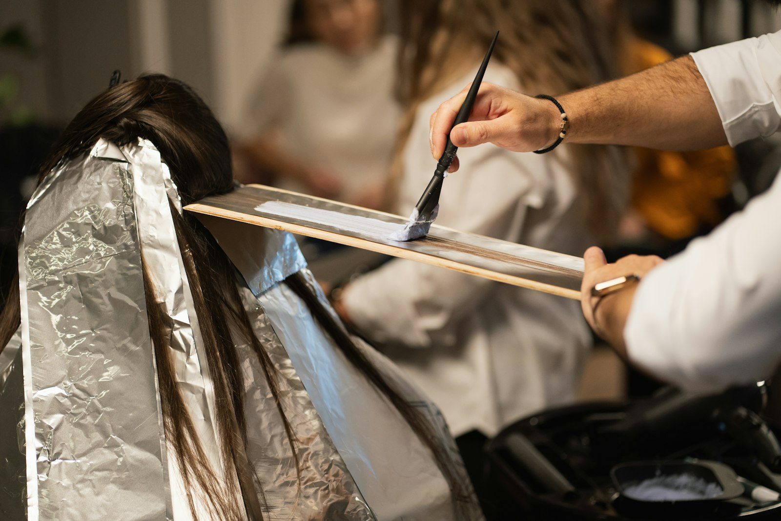 Colorist applying foils