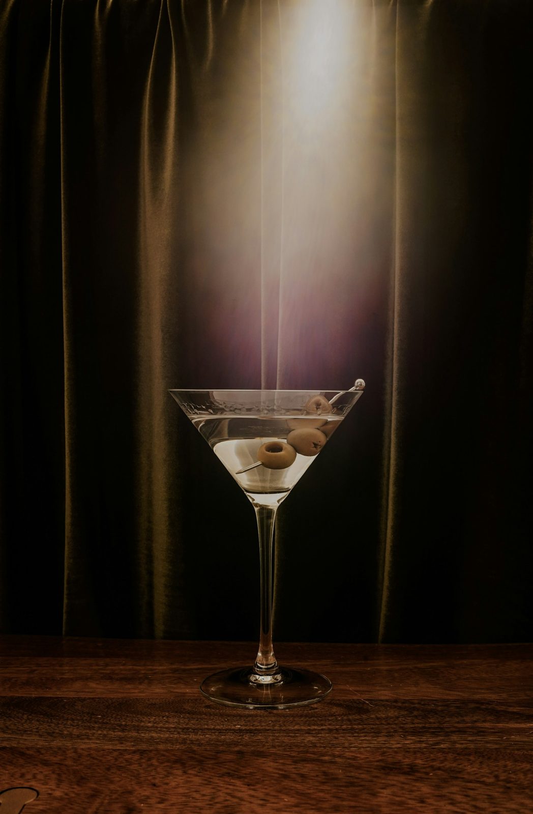 A martini on a dark bar