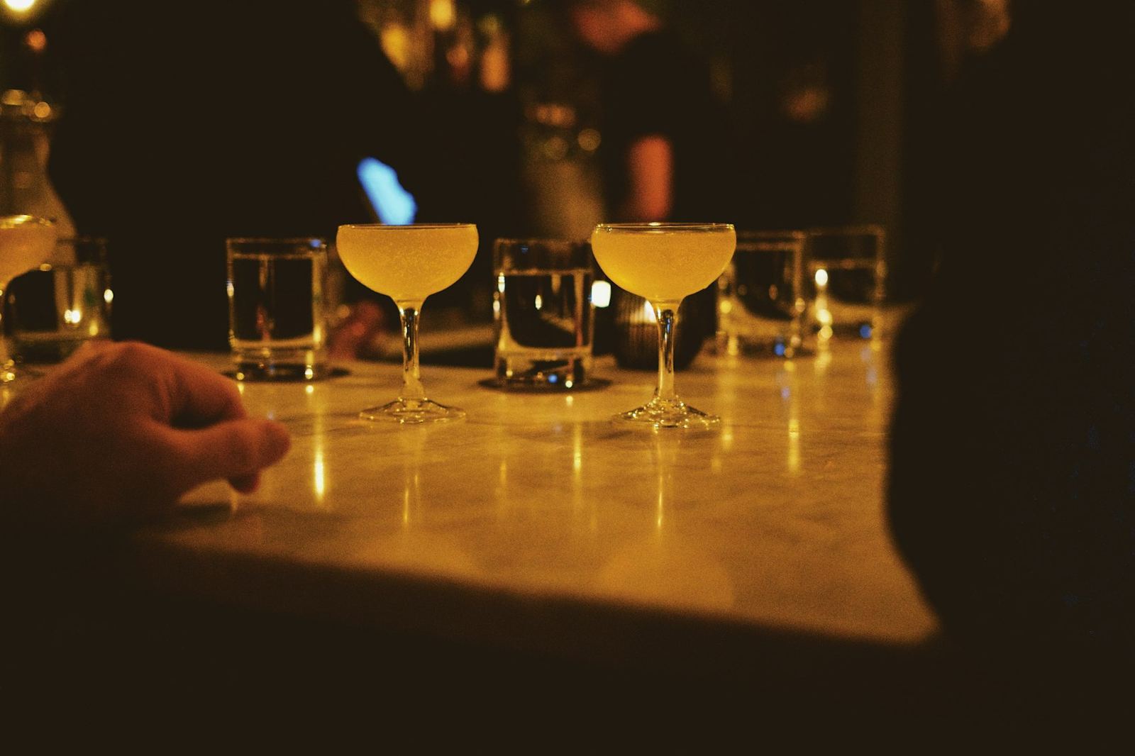 Glasses glowing on a candlelit bar