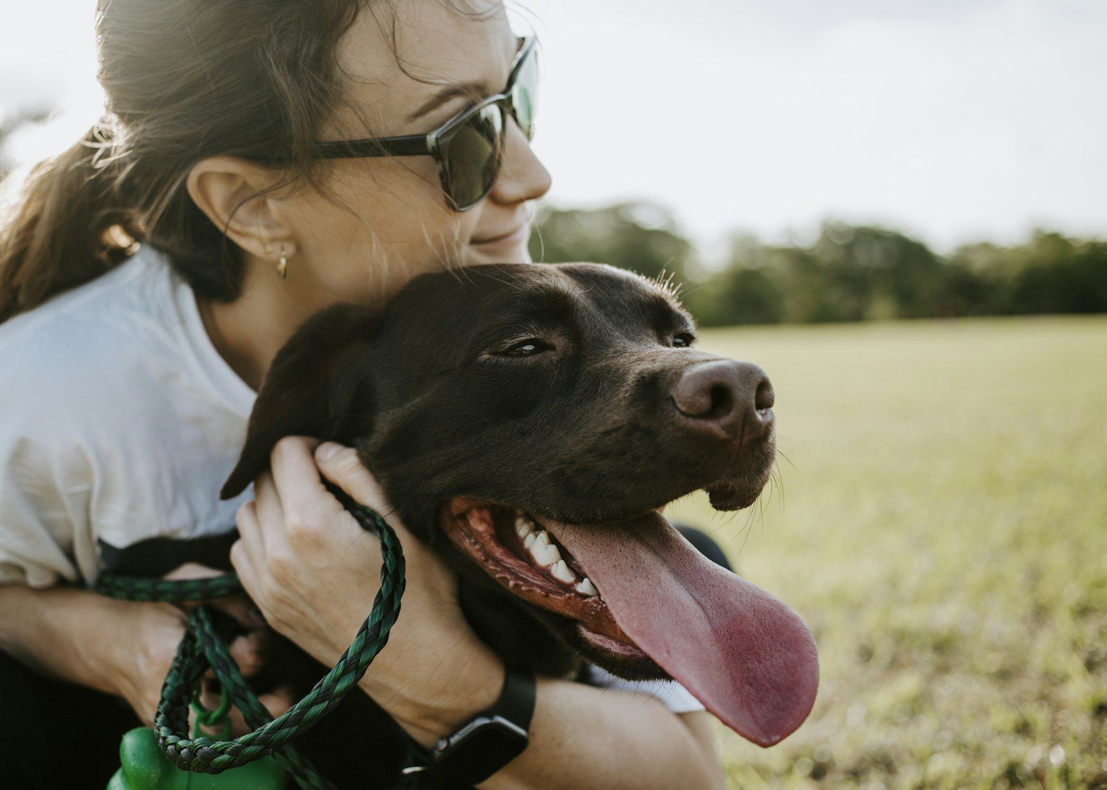 Owner hugging a black dog